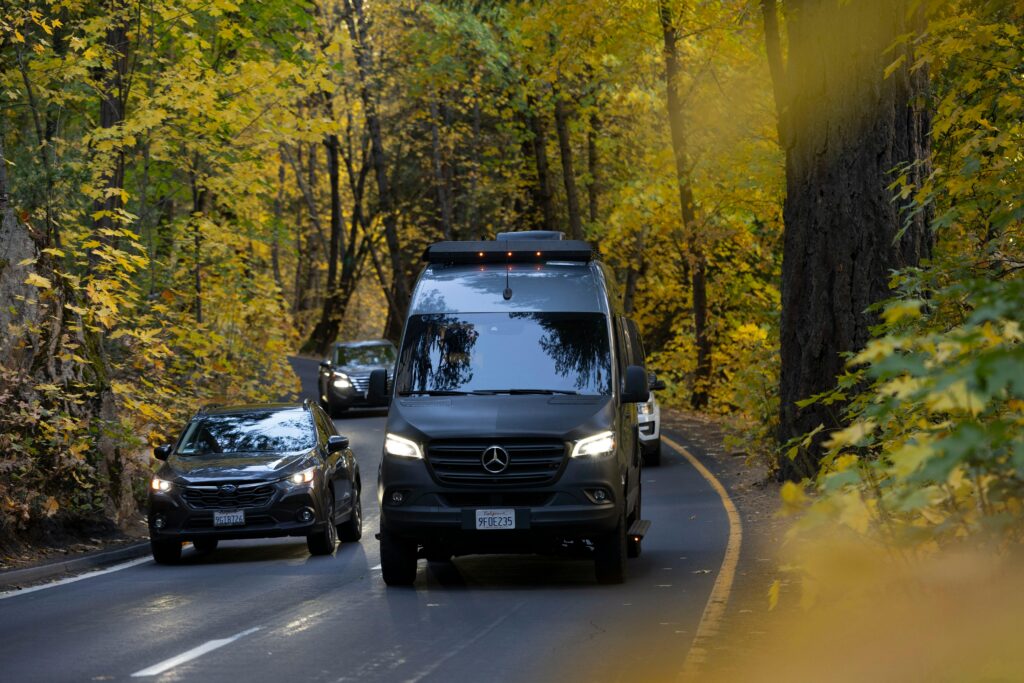 Camper Van Fall Drive Through fall foliage road.