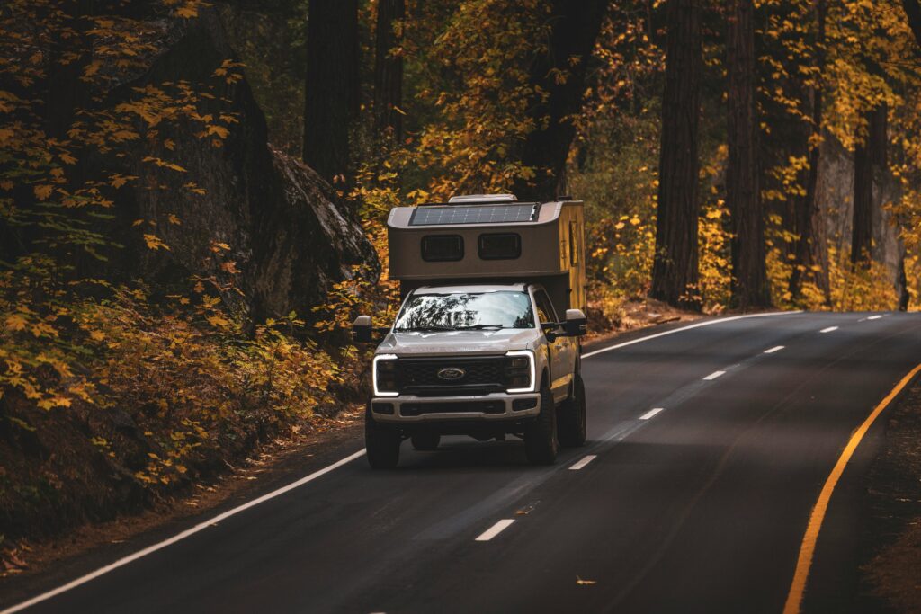 Autumn Drive Through Forested Road in a Truck Camper.